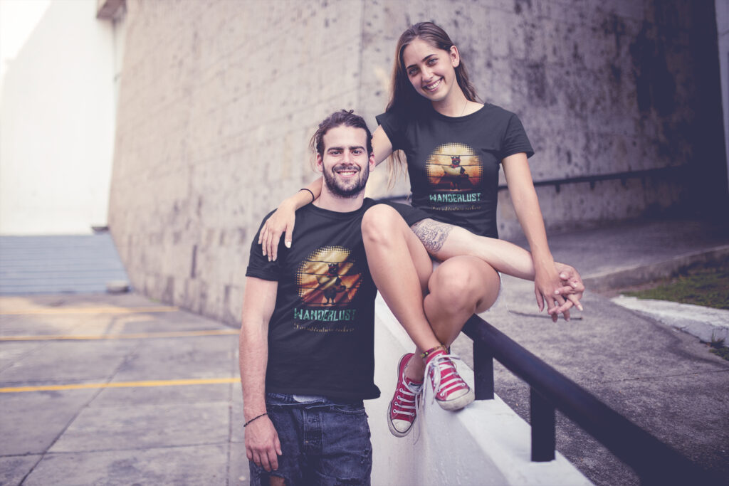 A couple wears Kitty Buccaneer's Sunset Quest T-Shirts.